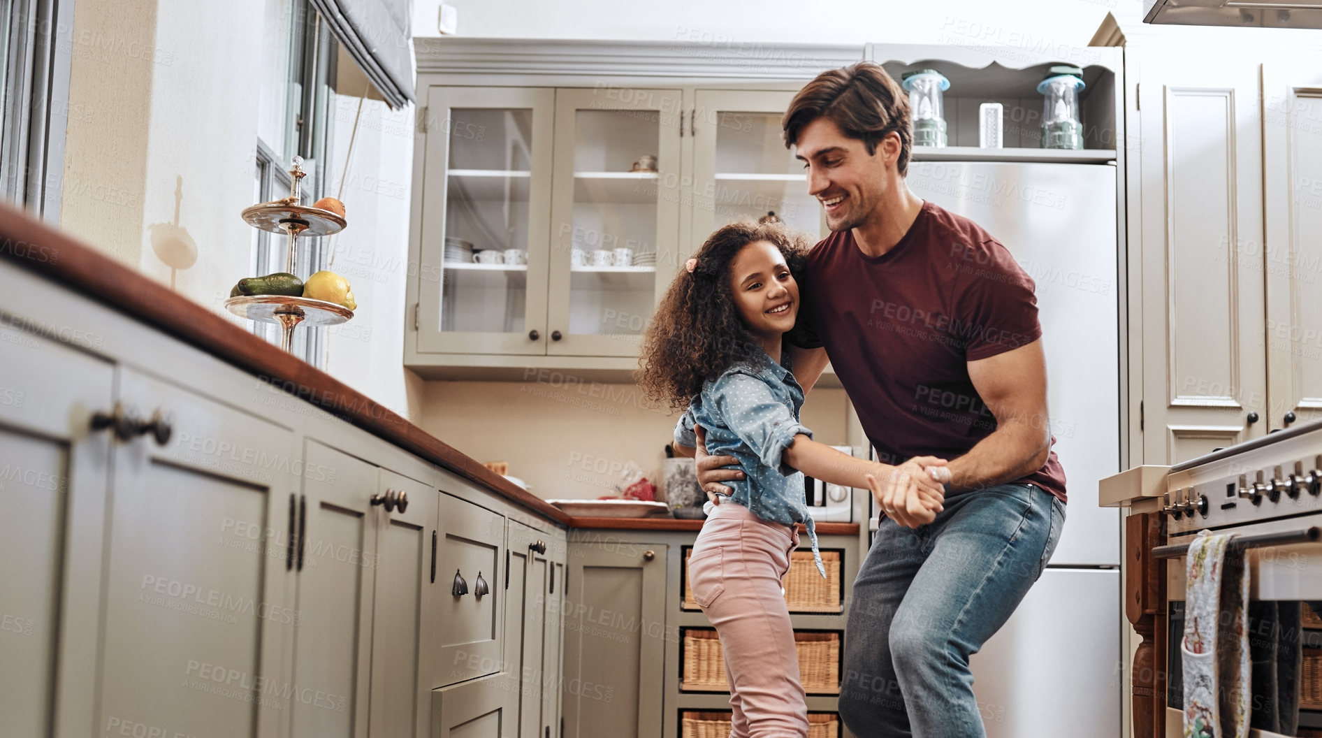 Buy stock photo Happy, man and kid with dancing in kitchen for playful fun, learning and bonding together. Family home, father and daughter with love in support for child development, connection and parenthood
