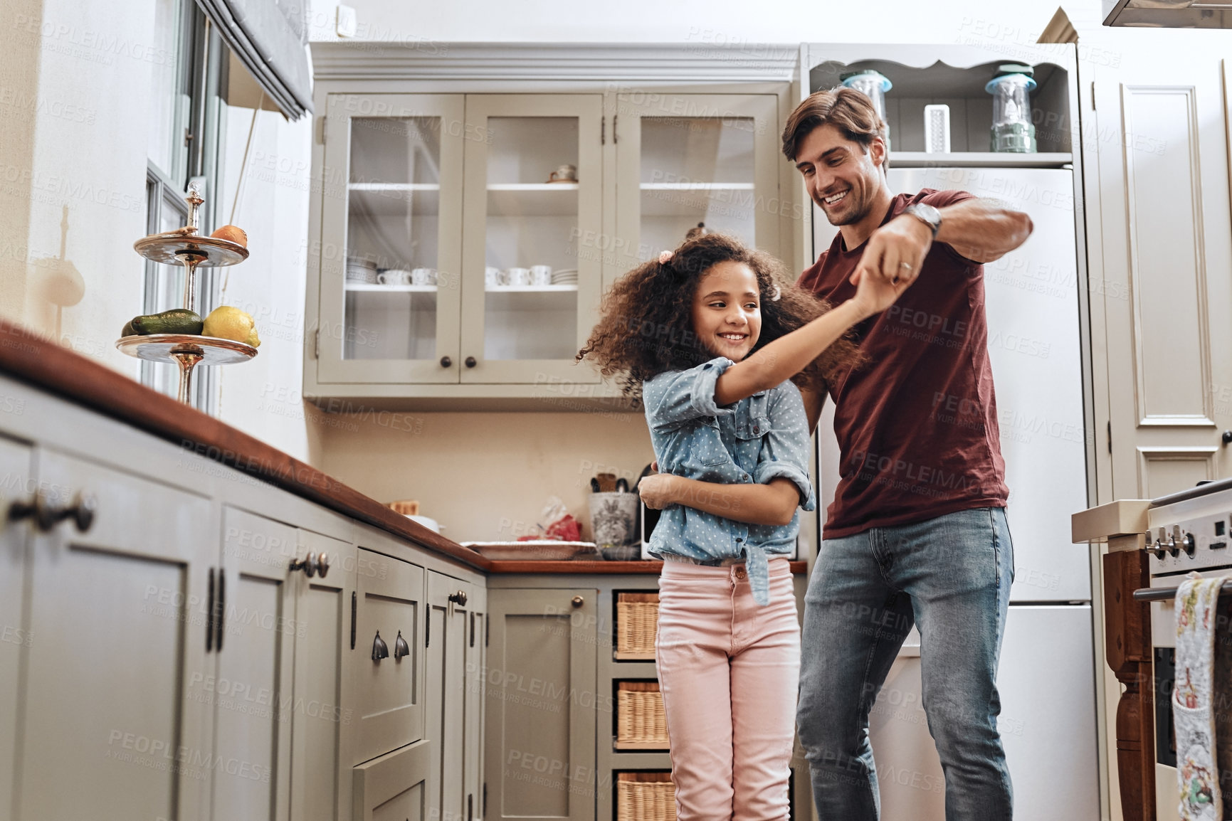 Buy stock photo Smile, man and kid with dancing in kitchen for playful fun, teaching and bonding together. Family house, father and daughter with love in support for child development, connection and parenthood