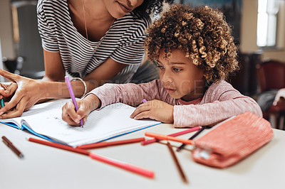 Buy stock photo Cropped shot of a woman helping her son with his homework at home