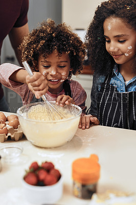 Buy stock photo Cropped shot of a young boy and girl baking in the kitchen at home