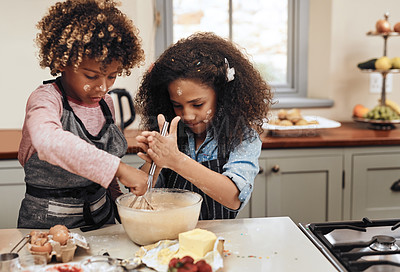 Buy stock photo Cropped shot of a young boy and girl baking in the kitchen at home