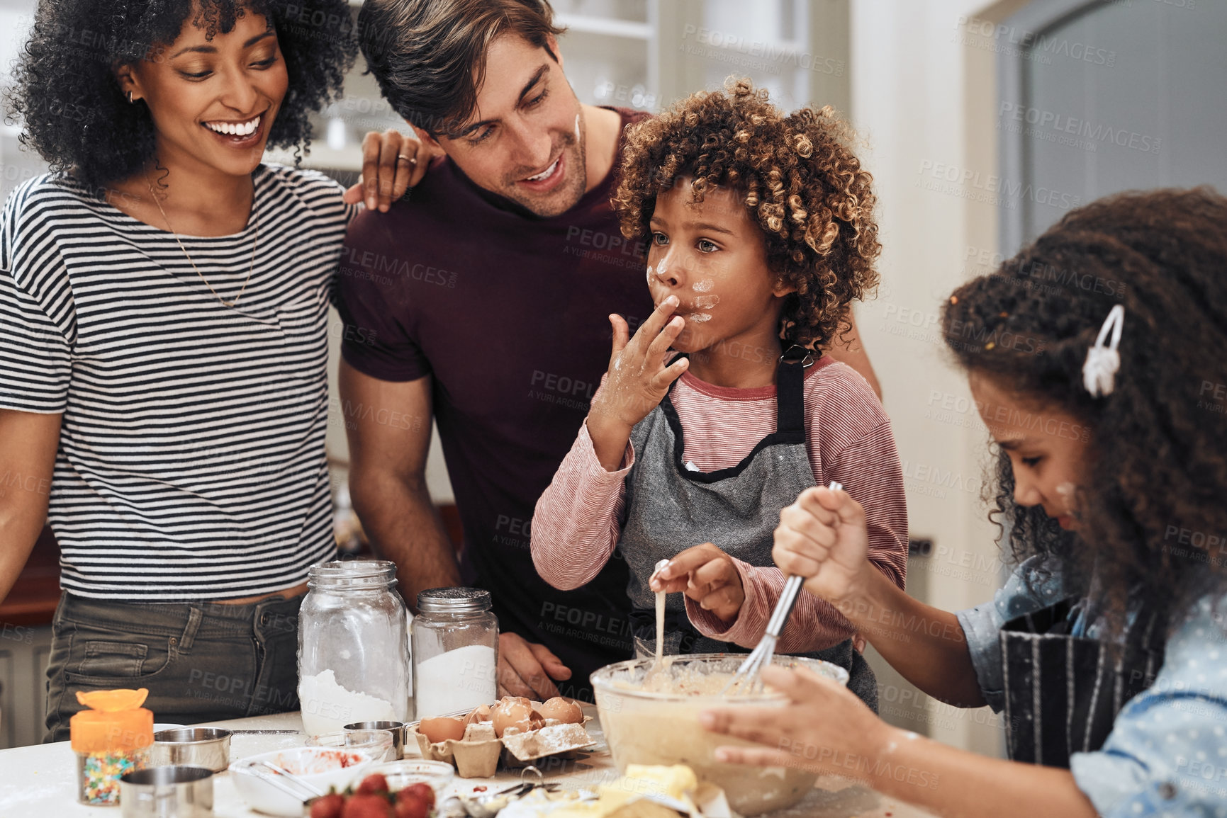 Buy stock photo Cropped shot of a young couple baking at home with their two children