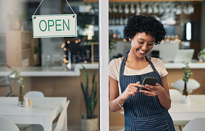 Buy stock photo Happy woman, waitress and phone with open sign in communication, social media or online post at cafe. Female person, barista or manager with smile for opening store on smartphone at coffee shop