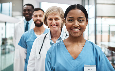 Buy stock photo Portrait of a group of medical practitioners standing together in a hospital