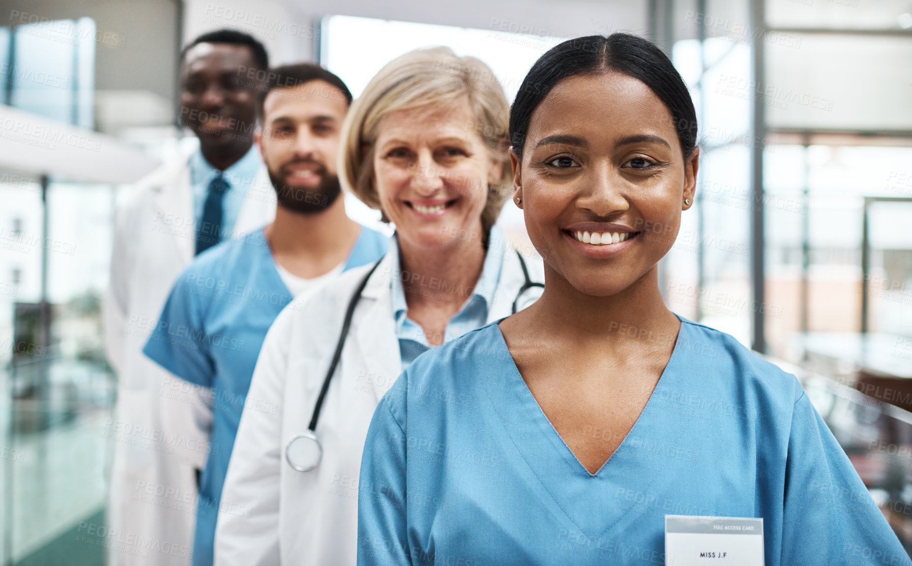 Buy stock photo Portrait of a group of medical practitioners standing together in a hospital