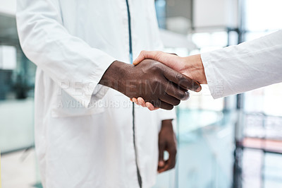 Buy stock photo Closeup shot of two doctors shaking hands in a hospital
