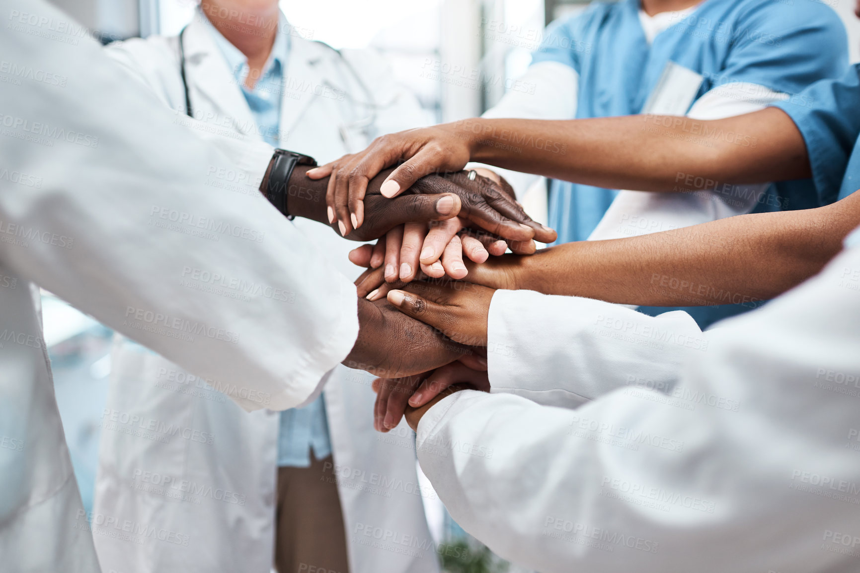 Buy stock photo Closeup shot of a group of medical practitioners joining their hands together in a huddle