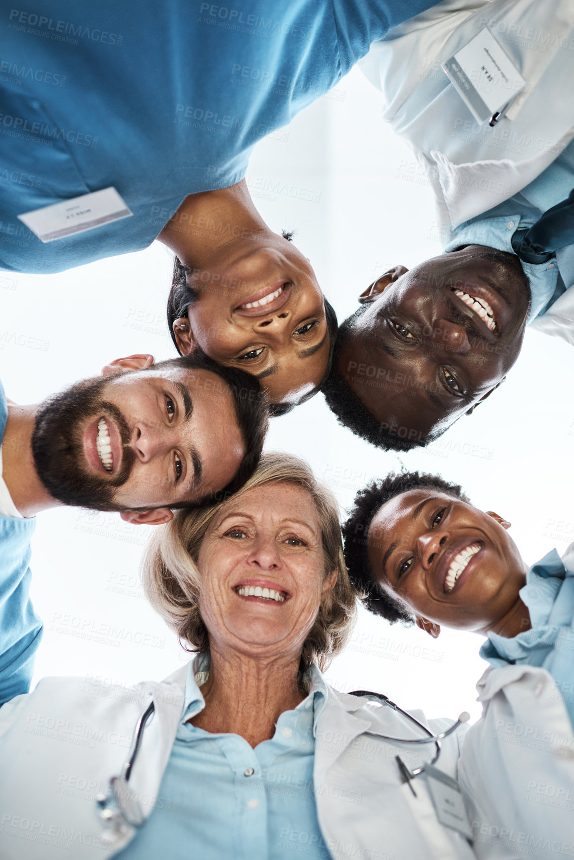 Buy stock photo Portrait of a group of medical practitioners standing together in a huddle
