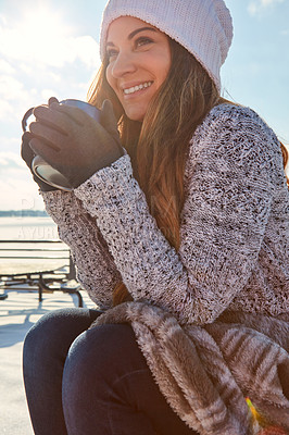 Buy stock photo Shot of a beautiful woman enjoying a hot beverage while sitting outside in the snow
