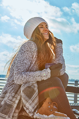 Buy stock photo Shot of a beautiful woman enjoying a hot beverage while sitting outside in the snow