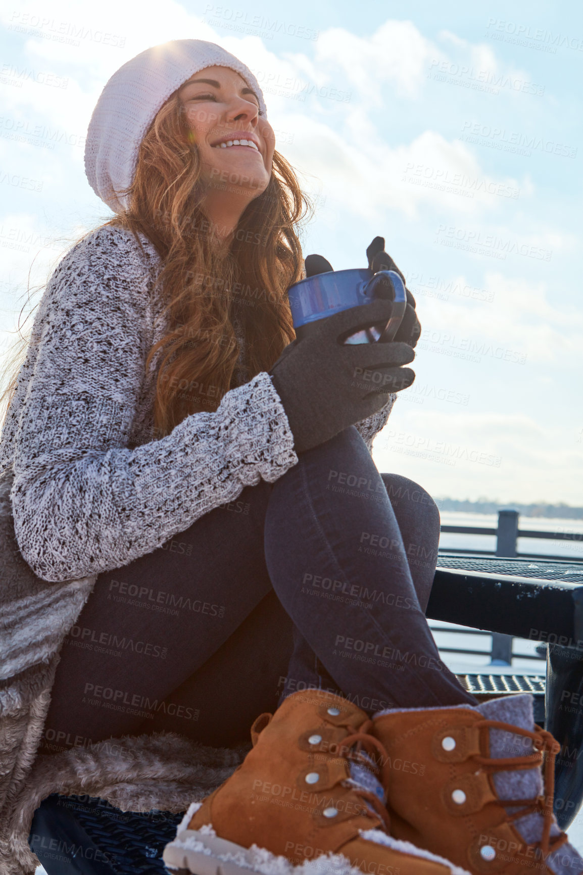 Buy stock photo Shot of a beautiful woman enjoying a hot beverage while sitting outside in the snow