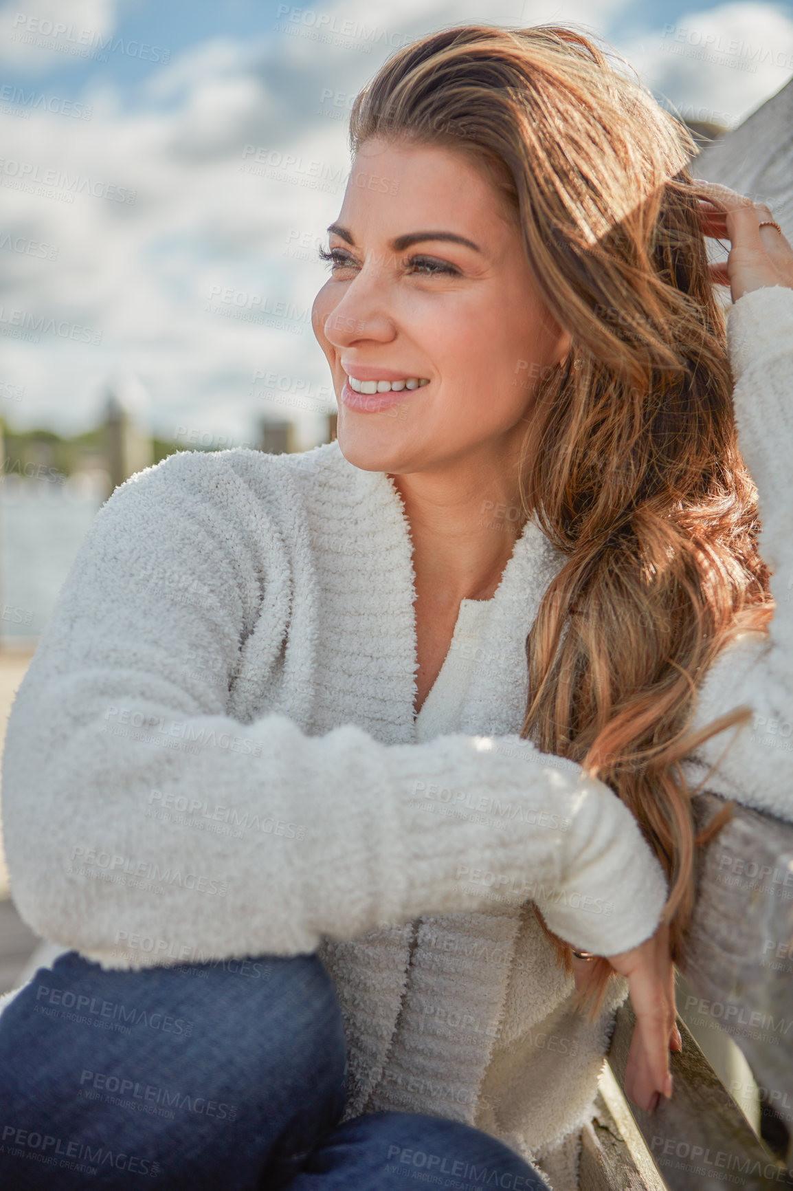 Buy stock photo Shot of a beautiful young woman relaxing outdoors