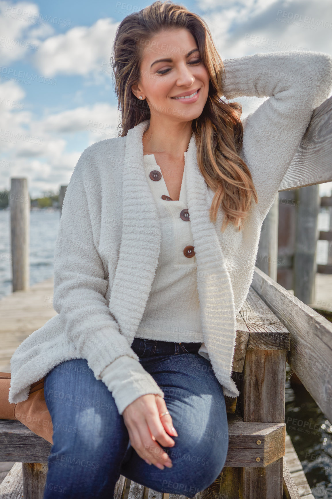 Buy stock photo Shot of a beautiful young woman relaxing outdoors