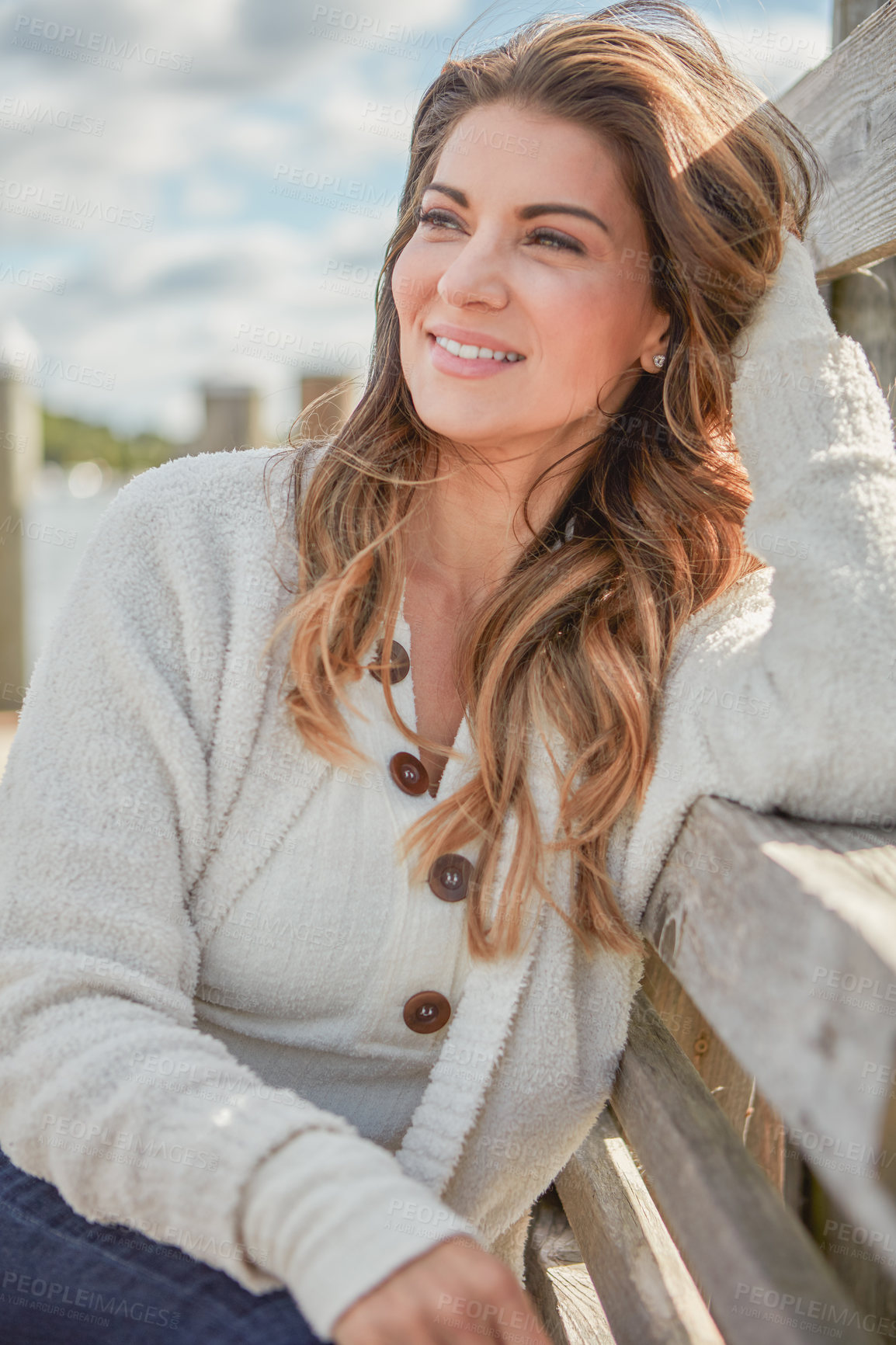 Buy stock photo Shot of a beautiful young woman relaxing outdoors