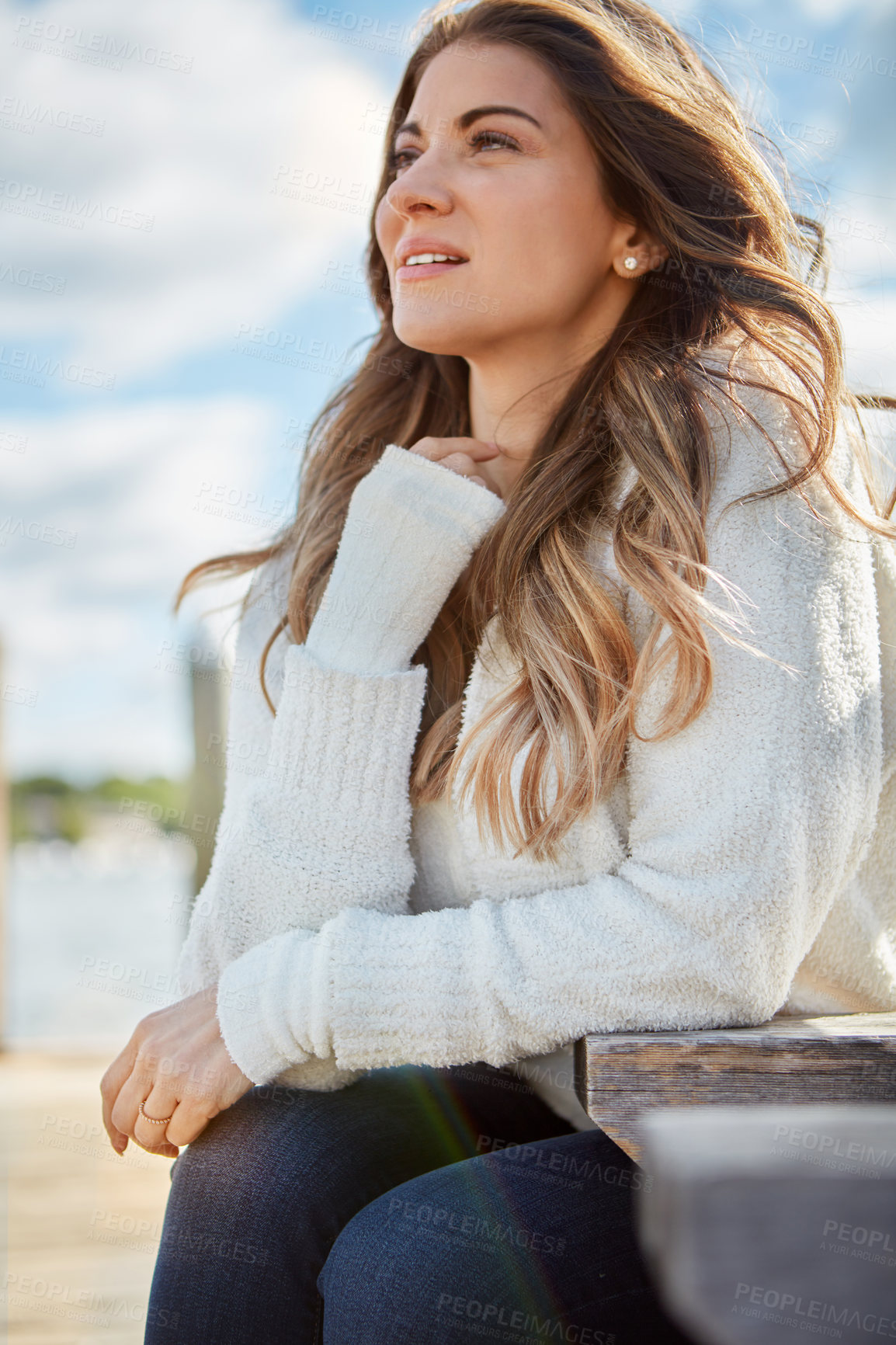 Buy stock photo Shot of a beautiful young woman relaxing outdoors