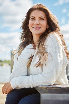 Buy stock photo Shot of a beautiful young woman relaxing outdoors