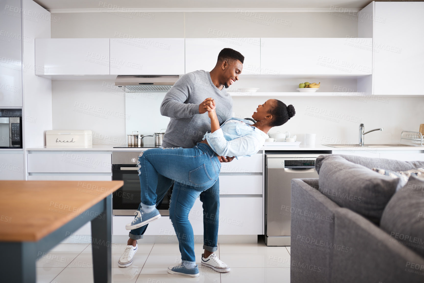 Buy stock photo Black couple, dancing and home for love, marriage and music for weekend rhythm in kitchen. Happy people, profile and romance in partnership or relationship, holding hands and dip for playful bonding