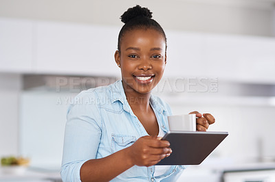 Buy stock photo Shot of a woman drinking coffee while using a digital tablet at home