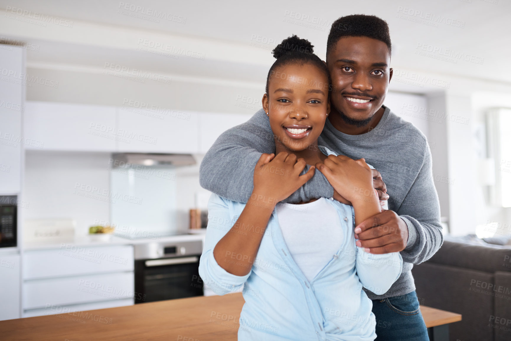 Buy stock photo Portrait, hug and black couple in kitchen, smile and relationship with love, romance and trust. African people, house and man with woman, embrace and marriage with happiness, joy and bonding together