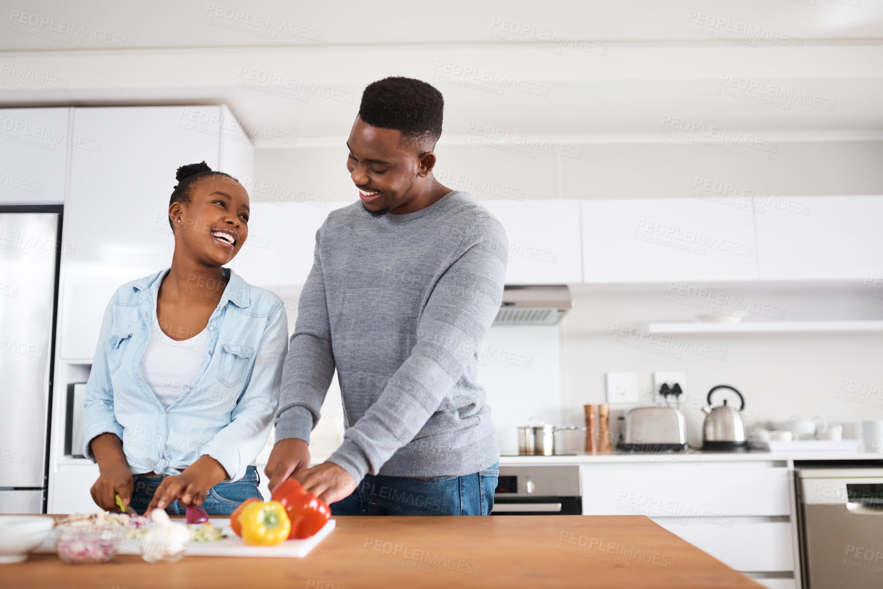 Buy stock photo Shot of a young couple cooking together at home