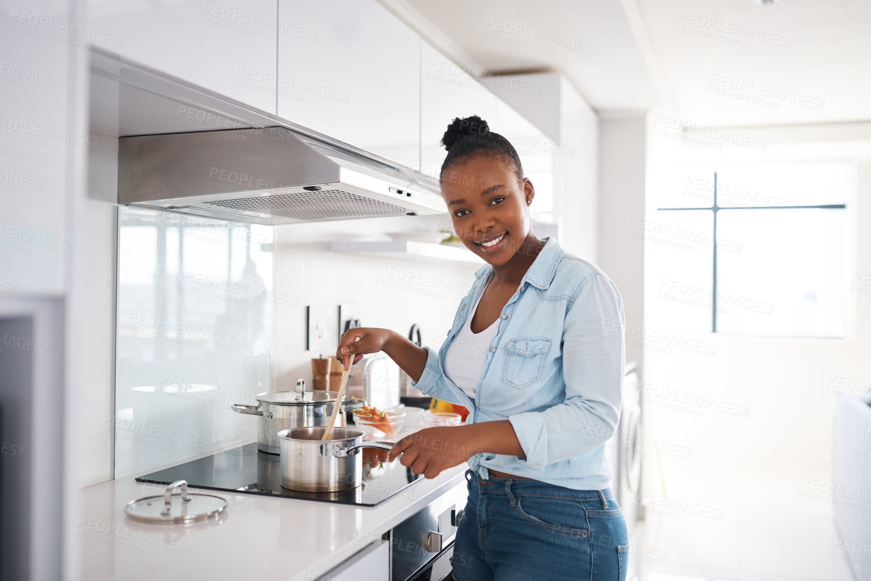 Buy stock photo Shot of a beautiful young woman cooking in her kitchen at home