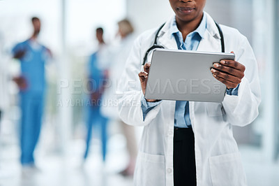 Buy stock photo Closeup shot of an unrecognisable doctor using a digital tablet in a hospital