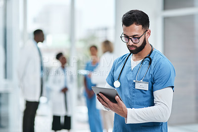 Buy stock photo Medical, doctor and tablet with a man in a clinic reading healthcare and wellness data at hospital. Employee, nurse and Indian male person with digital and health results on technology with research
