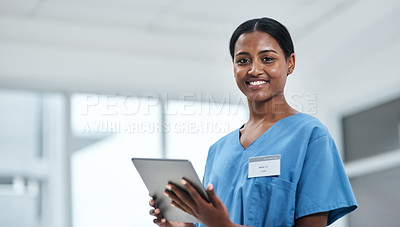 Buy stock photo Portrait of a young nurse using a digital tablet in a hospital