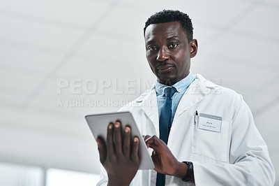 Buy stock photo Portrait of a mature doctor using a digital tablet in a hospital