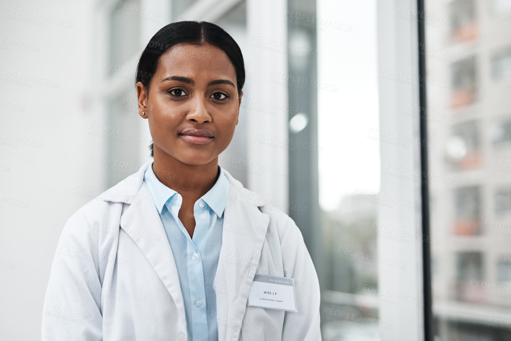 Buy stock photo Portrait of a young doctor standing in a hospital