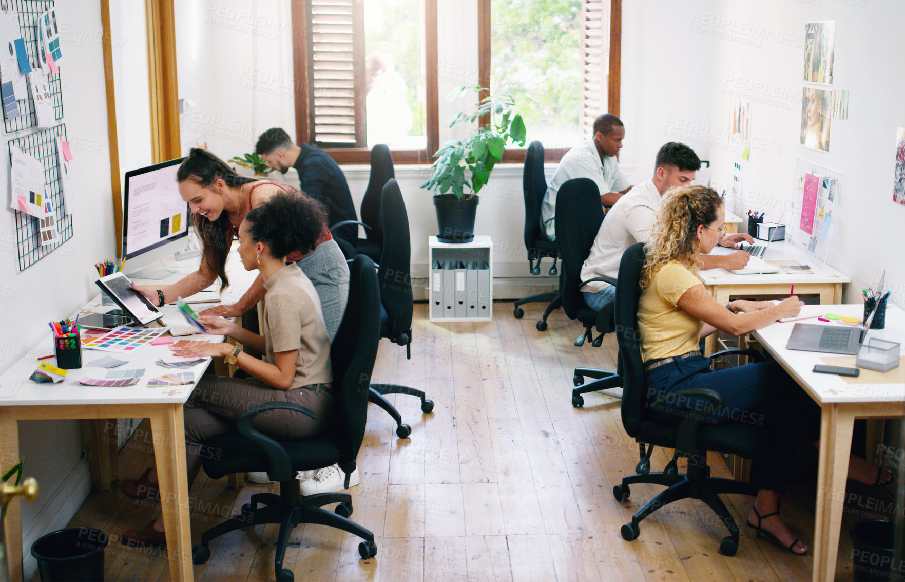 Buy stock photo Shot of a group of young businesspeople working together modern office