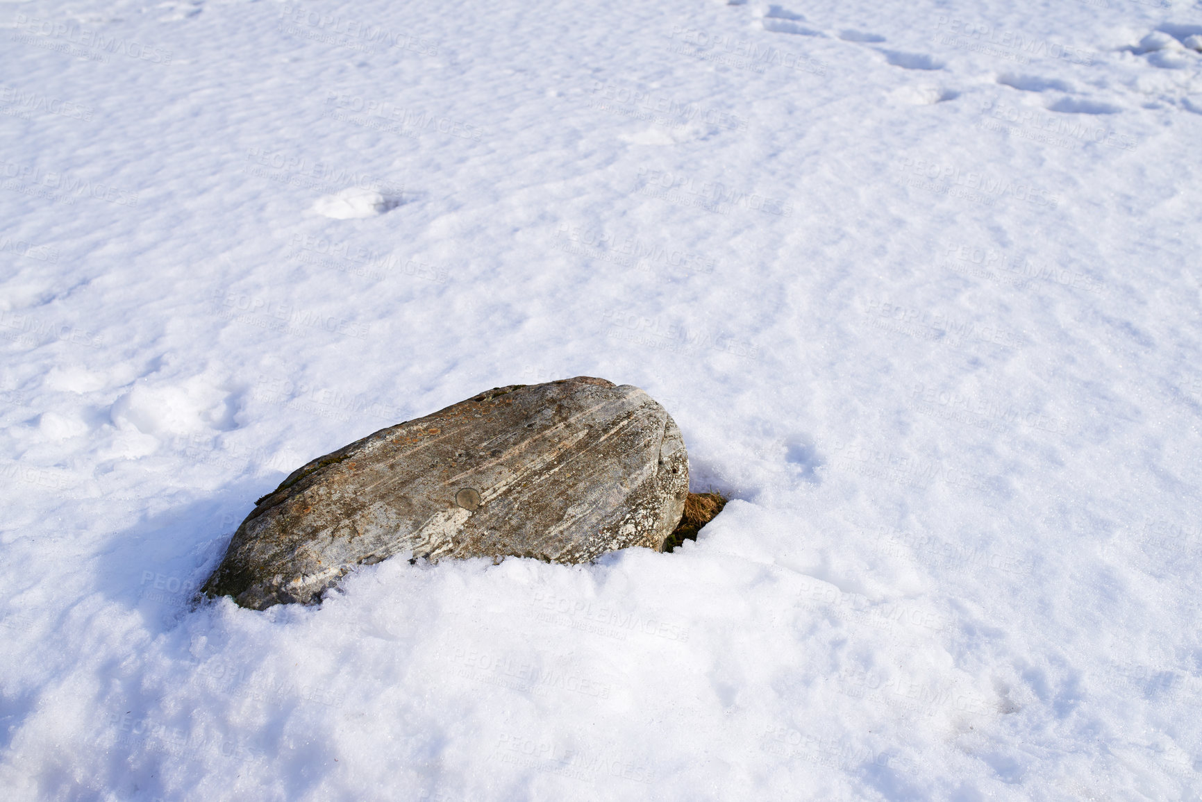 Buy stock photo Snow, nature and stone on ground outdoor in countryside for environment conservation. Frost, texture and rock in ice for cold weather with arctic season by eco friendly boulder in Denmark in winter.
