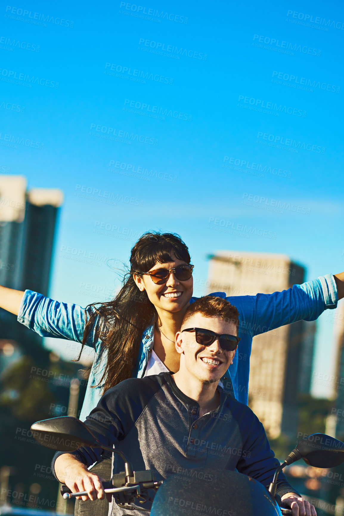 Buy stock photo Cropped shot of a young couple out for a ride in the city