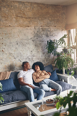 Buy stock photo Shot of a young couple relaxing together on a sofa at home