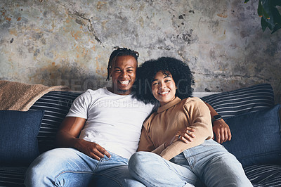 Buy stock photo Portrait of a young couple relaxing together on a sofa at home