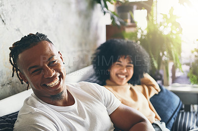 Buy stock photo Portrait of a young man relaxing with his girlfriend on a sofa at home