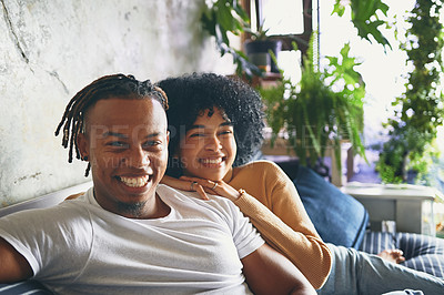 Buy stock photo Portrait of a young couple relaxing together on a sofa at home