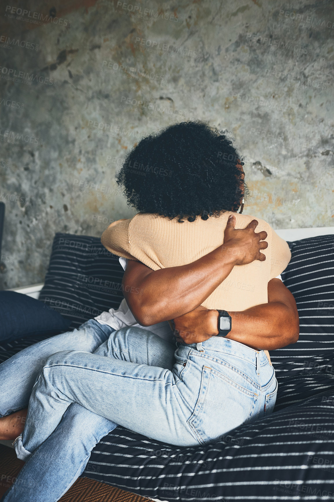 Buy stock photo Shot of a young couple hugging each other at home