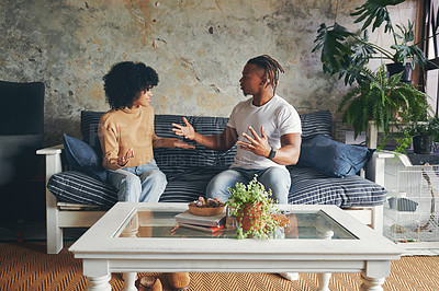 Buy stock photo Shot of a young couple having an argument at home