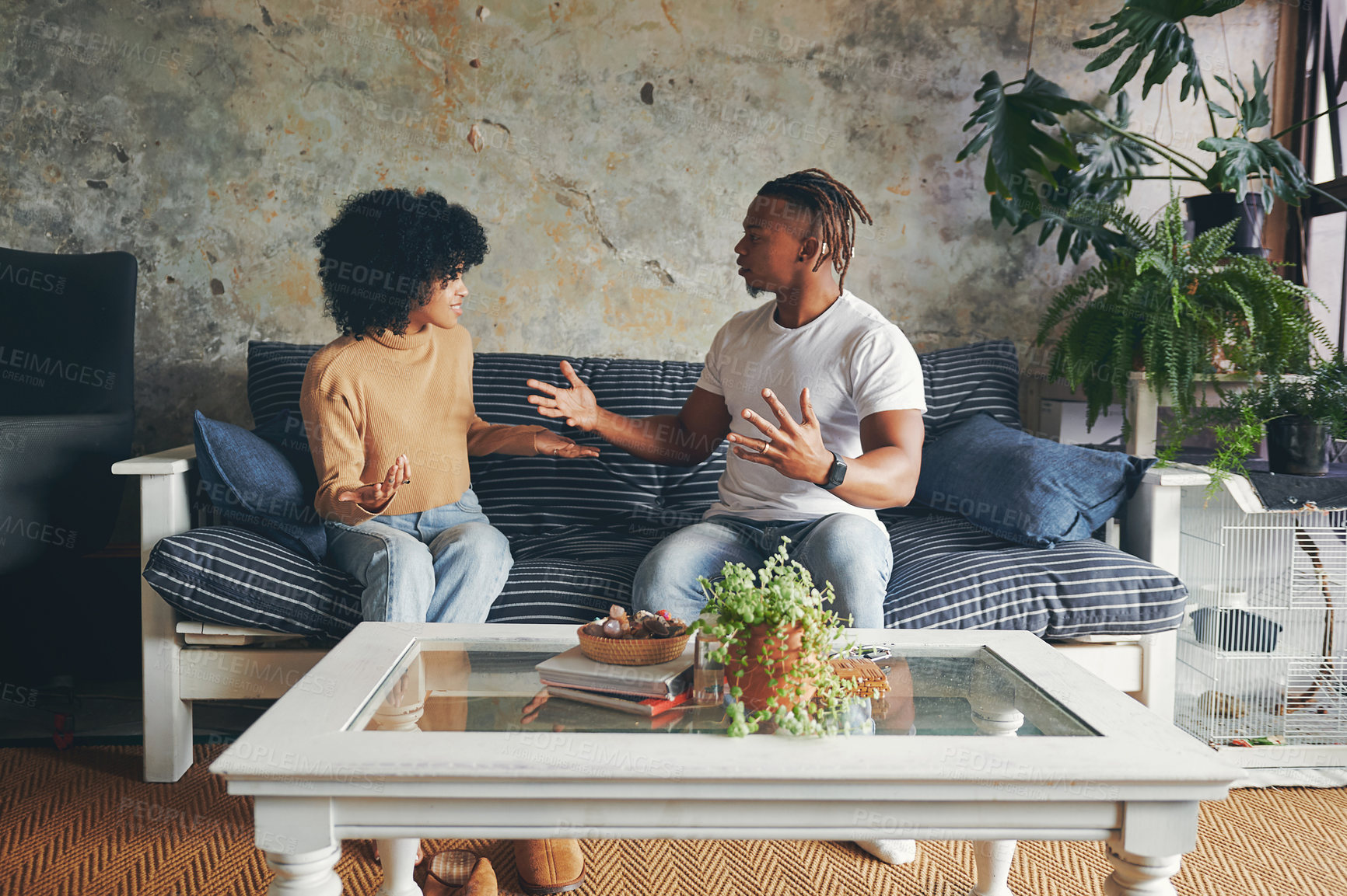 Buy stock photo Shot of a young couple having an argument at home