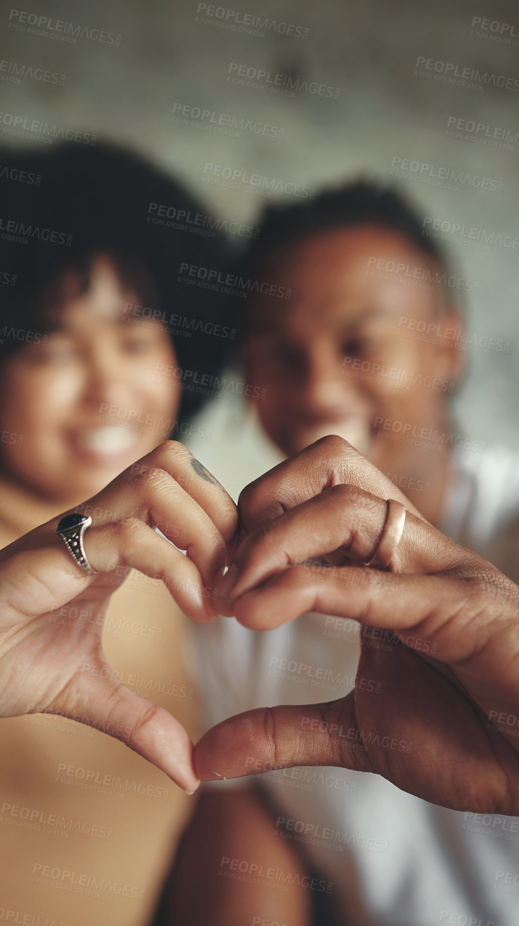 Buy stock photo Heart, hands and couple with love, gesture and bonding for romance in relationship, commitment and house. Care, shape and people in living room, dating and together in apartment, smile and home