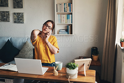 Buy stock photo Shot of a young woman experiencing stress while working from home