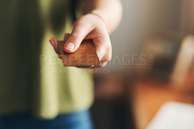 Buy stock photo Shot of a woman using a credit card while working from home