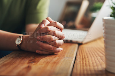 Buy stock photo Shot of an unrecognisable woman sitting at a desk in a home office with her hands clasped