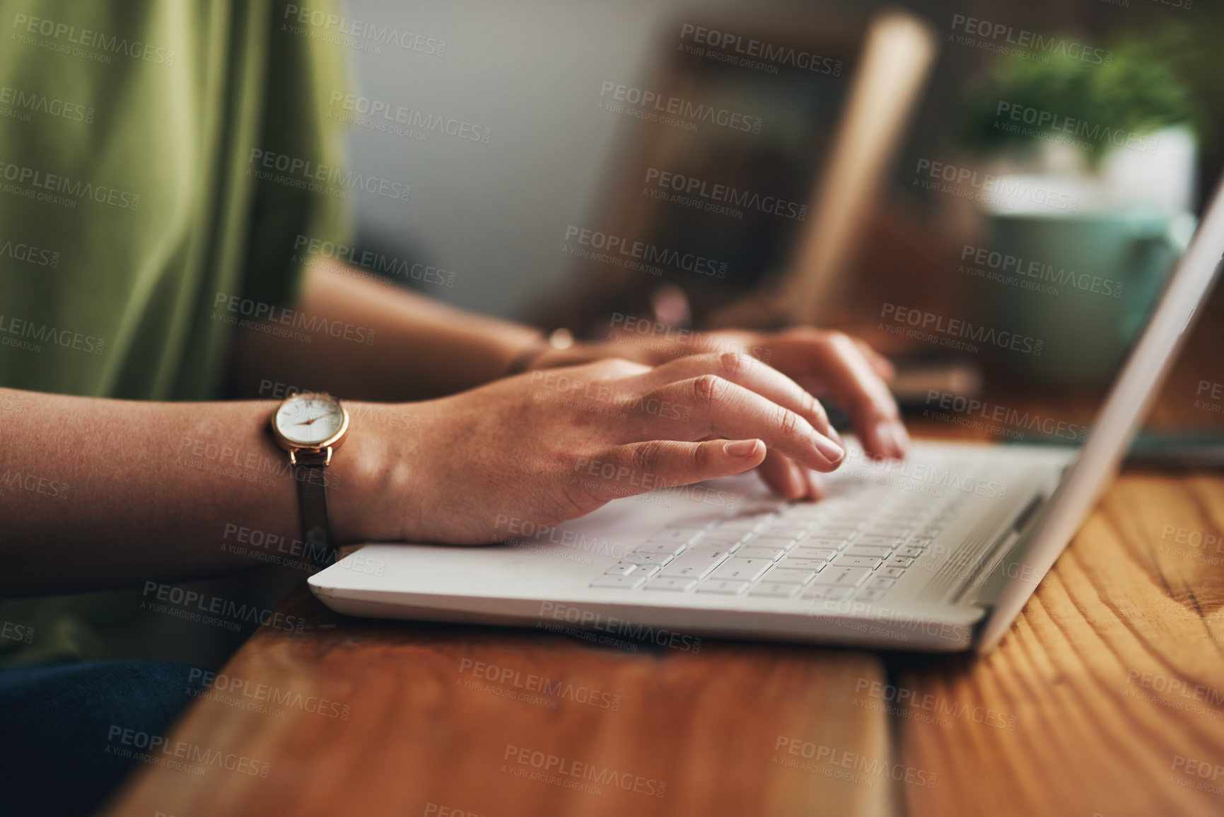 Buy stock photo Cropped shot of a woman using a laptop while working from home