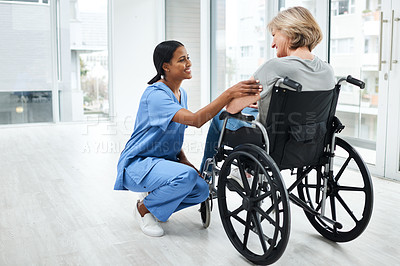 Buy stock photo Shot of a young nurse caring for a senior woman in a wheelchair