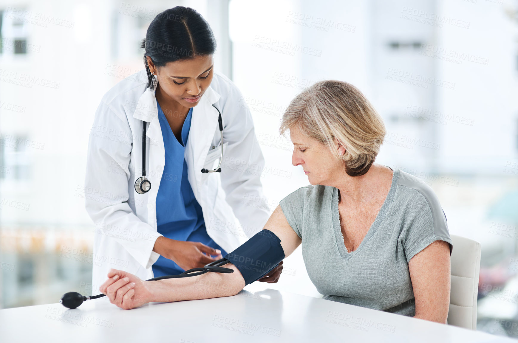 Buy stock photo Doctor, senior woman and blood pressure gauge with healthcare, gp and consultation. Pensioner, patient and medical with professional, wellness and exam with caregiver, checkup or monitor with service