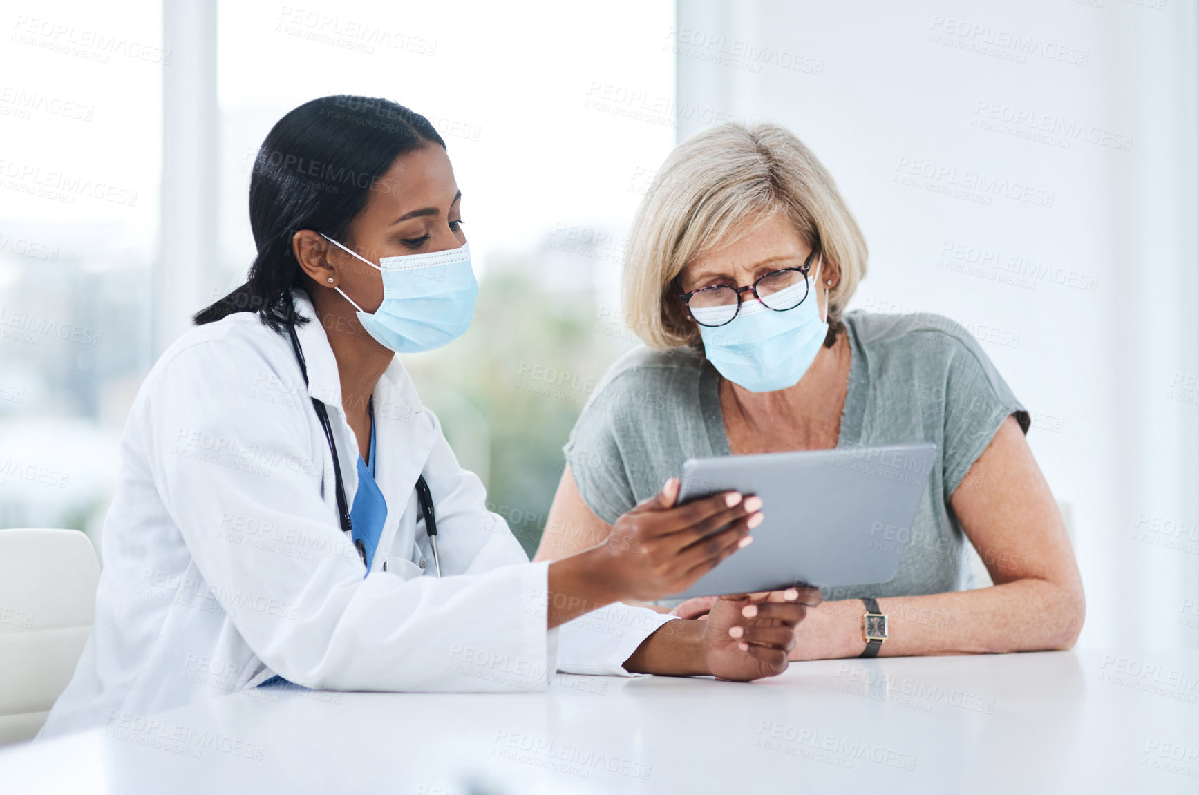 Buy stock photo Doctor, woman and tablet for consulting with mask, talking and advice for healthcare, wellness and support. Medic, patient and hospital for covid with mobile touchscreen app, results and feedback