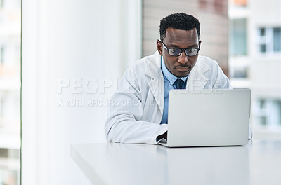Buy stock photo Healthcare, research and man doctor on laptop in consultation office for reading in hospital. Online, medical and African male health expert checking medical news, development or clinic schedule