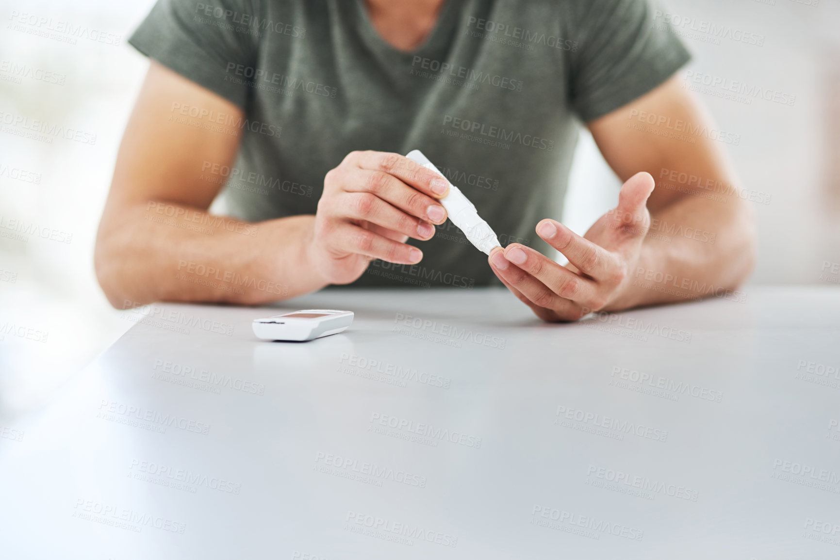 Buy stock photo Shot of an unrecognisable man using a blood sugar test on his finger